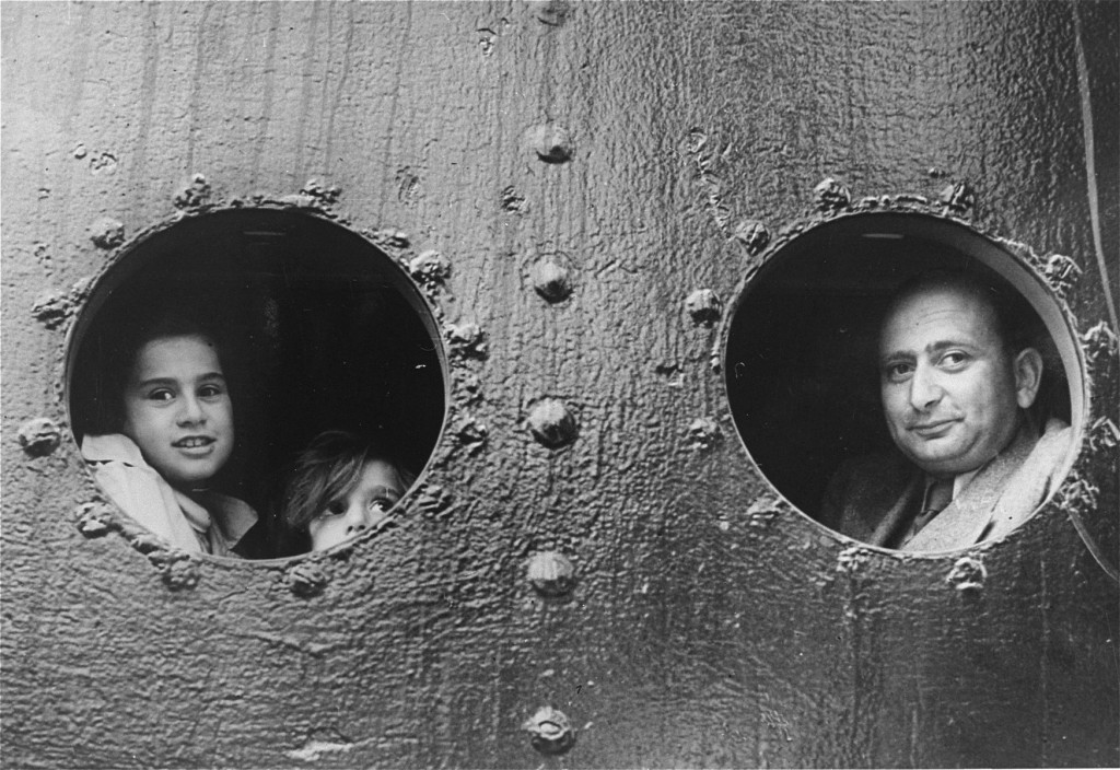 German Jewish refugees look through the windows of the "St. [LCID: 5009]