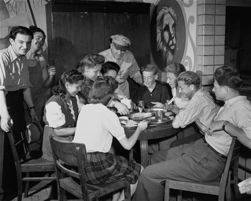 An officer of the United Nations Relief and Rehabilitation Administration (UNRRA) visits with a group of young refugees. Eschwege displaced persons camp, Germany, July 7, 1946.