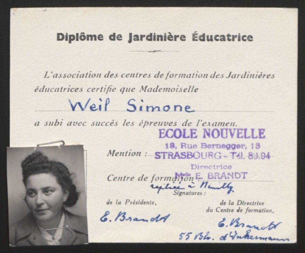 Printed education certification with handwritten details in blue ink. A photograph of a woman with dark hair in an updo and light skin tone is stapled to the bottom left corner.
