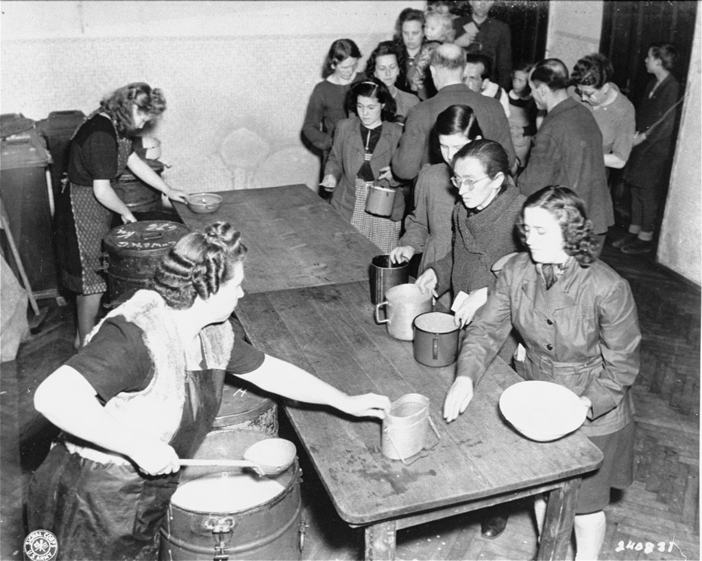 Hot food is served at the displaced persons camp on Arzbergerstrasse. [LCID: 81587]