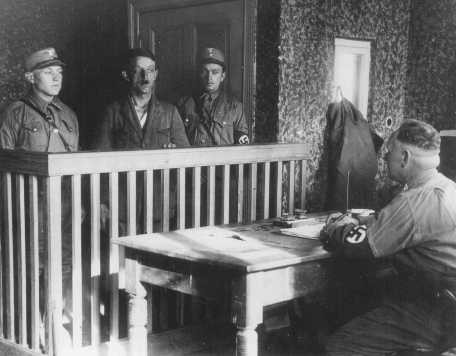 Members of the SA interrogate a newly arrived prisoner in the Oranienburg camp near Berlin.