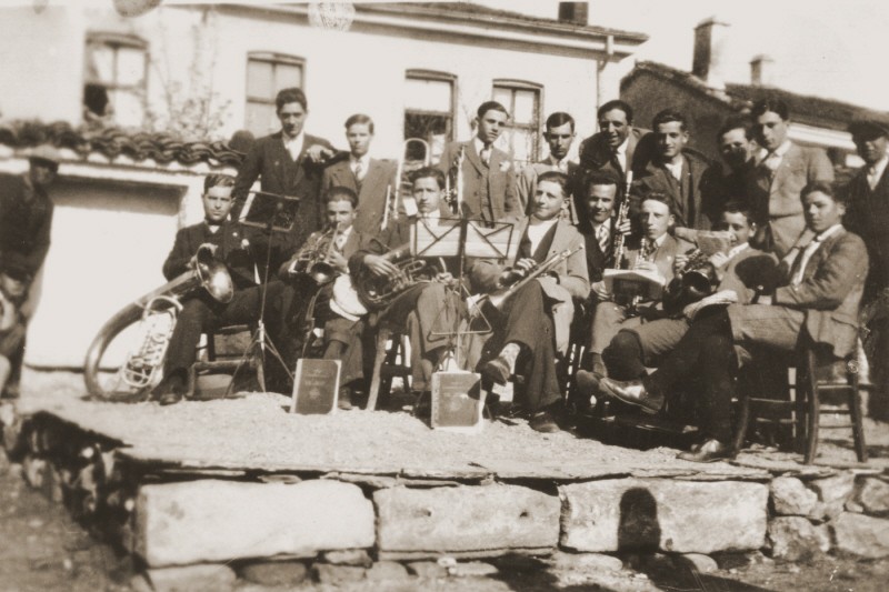 A group of Macedonian Jewish youth, members of a band, pose with their instruments on a makeshift stage in Bitola.