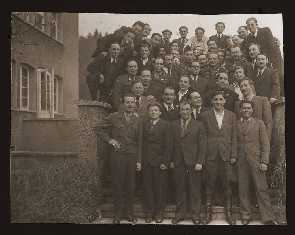Jewish displaced persons (DPs) and American soldiers at the Heidenheim DP camp, circa 1946–1947. Leon Kliot (Klott) is standing on the far right, third from the top.