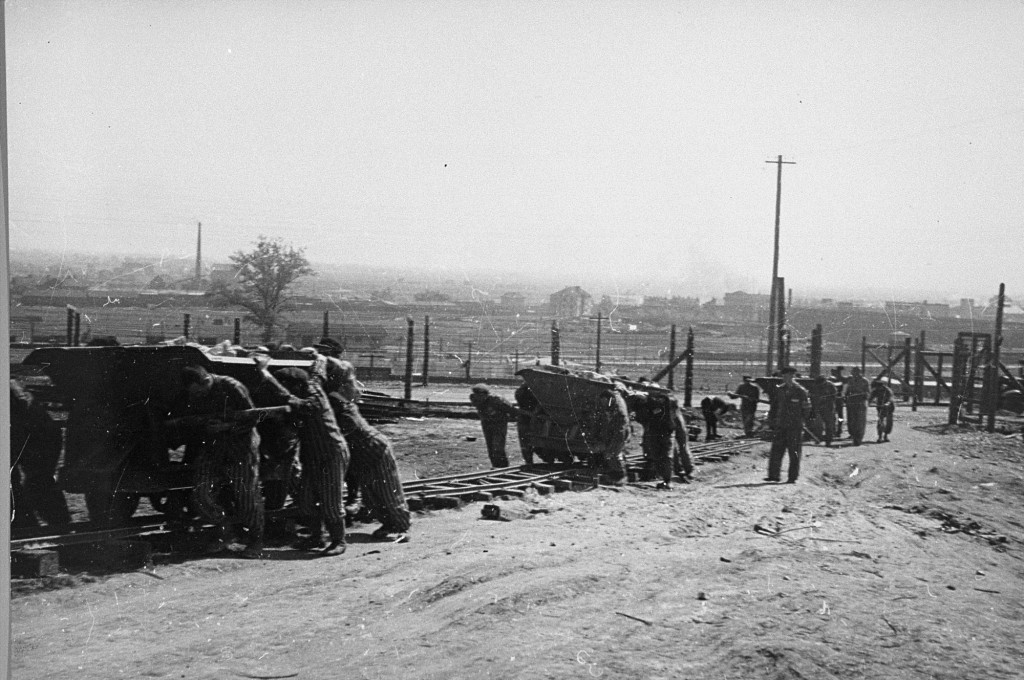 A kapo oversees prisoners at the Płaszów camp