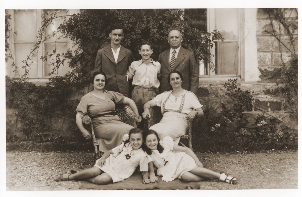 Members of the Amarillo family pose outside their home in Salonika. [LCID: 97282]