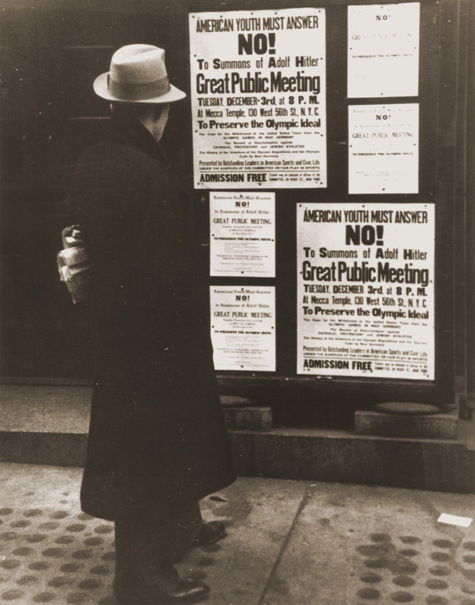 A pedestrian pauses to read a notice announcing an upcoming public meeting, scheduled for Tuesday, December 3, to urge Americans ...