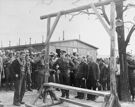 During an official tour of the newly liberated Ohrdruf concentration camp, an Austrian Jewish survivor describes to General Dwight Eisenhower and the members of his entourage the use of the gallows in the camp.