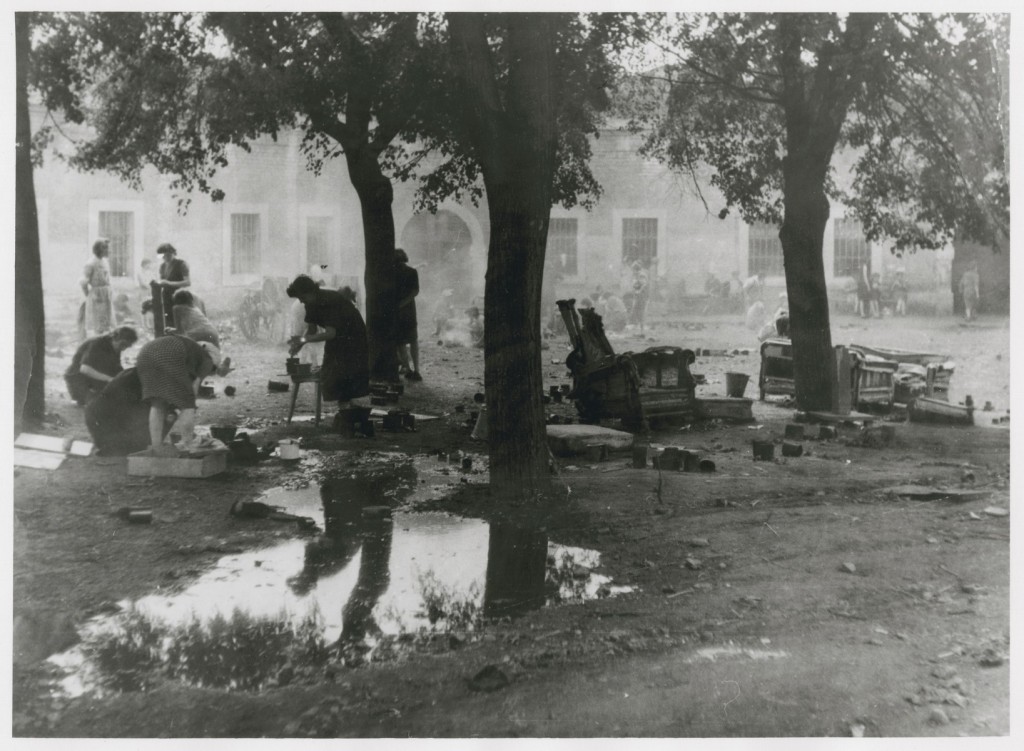 Women prepare food outdoors in the Theresienstadt ghetto.