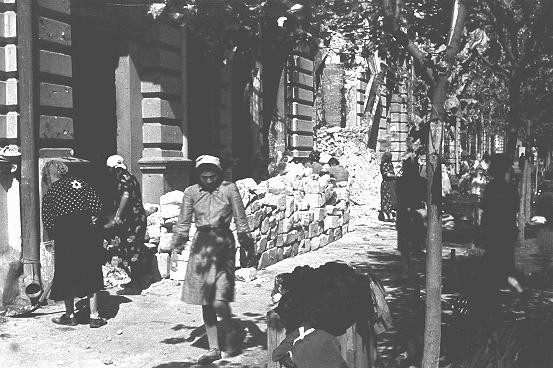 Jewish women at forced labor in the process of clearing rubble from the main street. [LCID: 03330]