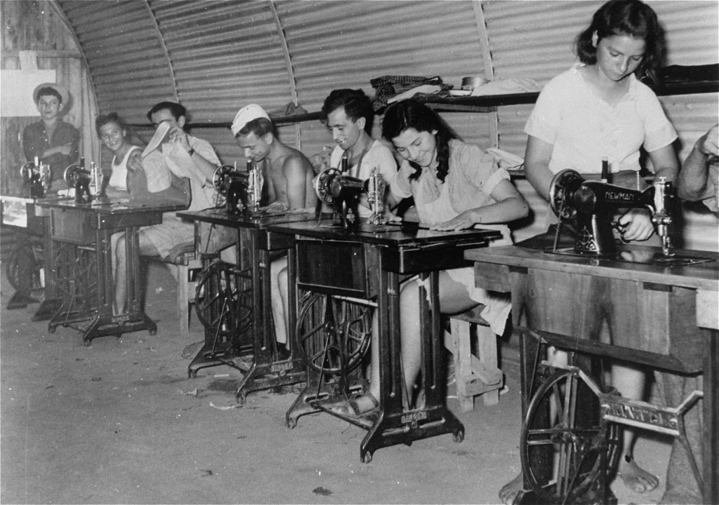 Jewish refugee youths, prevented by the British from landing in Palestine, learn sewing at a detention camp.