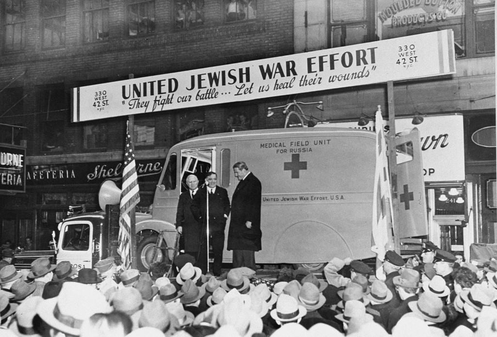 Dr. Joseph Tenenbaum stands with Fiorello LaGuardia and Rabbi Stephen S. Wise in front of a medical field unit that was sent to the Soviet Union. The unit was sponsored by the United Jewish War Effort. New York City, NY, 1943. 
Fiorello Henry LaGuardia (1882-1947) was a US Republican Congressman from New York, three term mayor of New York City and Director General of the United Nations Relief and Rehabilitation Administration (UNRRA). Dr. Joseph Tenenbaum (1887-1961) was the founder and chairman of the Joint Boycott Council of the American Jewish Congress and a member of several other anti-Nazi organizations. Rabbi Stephen S. Wise (1874-1949) was a co-founder of the NAACP and assisted in the creation of several other Jewish organizations, such as the World Jewish Congress. Rabbi Wise was an early and outspoken opponent of Nazism. In 1942, he received the Reigner cable, which confirmed the existence of the Nazi’s “Final Solution.”
