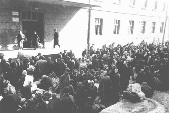 Jews outside the "Monopol" tobacco factory, used as a transit camp by Bulgarian authorities during deportations from Macedonia to ... [LCID: 79614]
