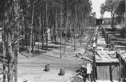 The fenced perimeter and an entrance to the women's camp at Wöbbelin. [LCID: 09275]