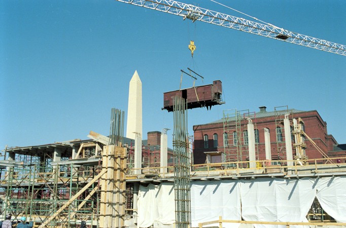 Installation of the railcar at the construction site of the United States Holocaust Memorial Museum. [LCID: n0633001]