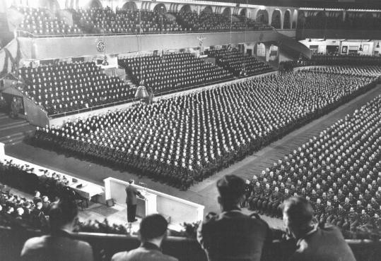  At Berlin's Sportpalast arena, Hitler (at podium) delivers a speech to thousands of Nazi party officials. [LCID: 87883]