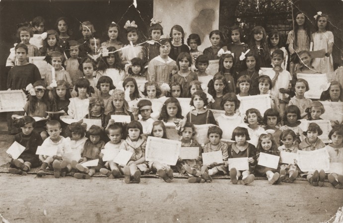 Group portrait of children holding their diplomas at a school in Bitola.
