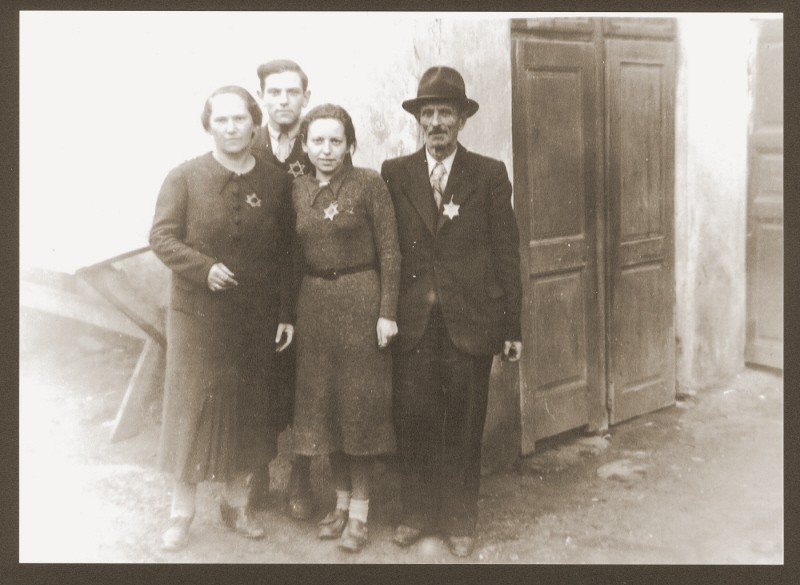 Portrait of the Weidenfeld family wearing Jewish badges in the Czernowitz (Cernauti) ghetto shortly before their deportation to Transnistria. [LCID: 30087]