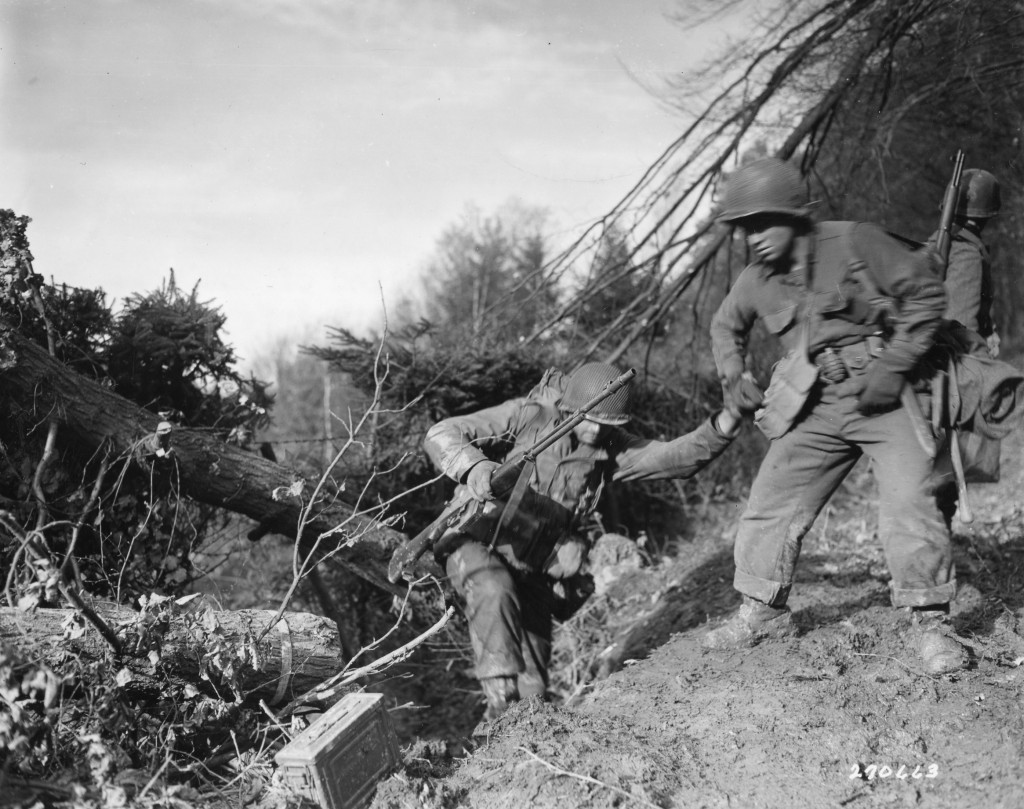 Members of the US Army 4th Infantry Division climb in the Hürtgen Forest, Germany, 1944