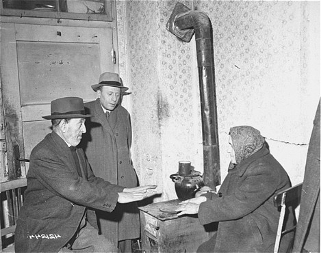  A Jewish family in the Hallein displaced persons camp uses coal provided by the President's Escapee Program, an American aid initiative. [LCID: 81586]