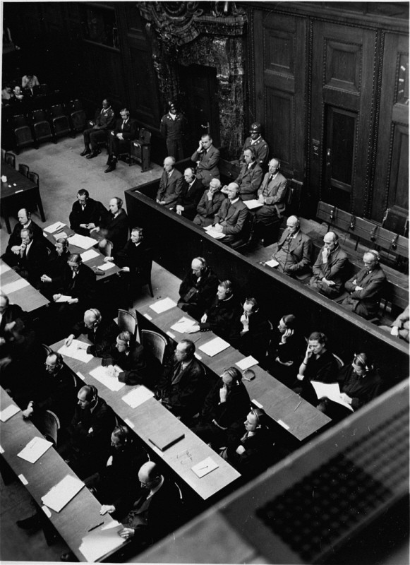 The defendants in the dock (right) and their lawyers (center) listen to trial proceedings during the High Command Case. [LCID: 16822]