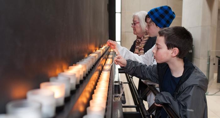 Lighting candles in remembrance at the United States Holocaust Memorial Museum, Washington DC, during Days of Remembrance, 2014.