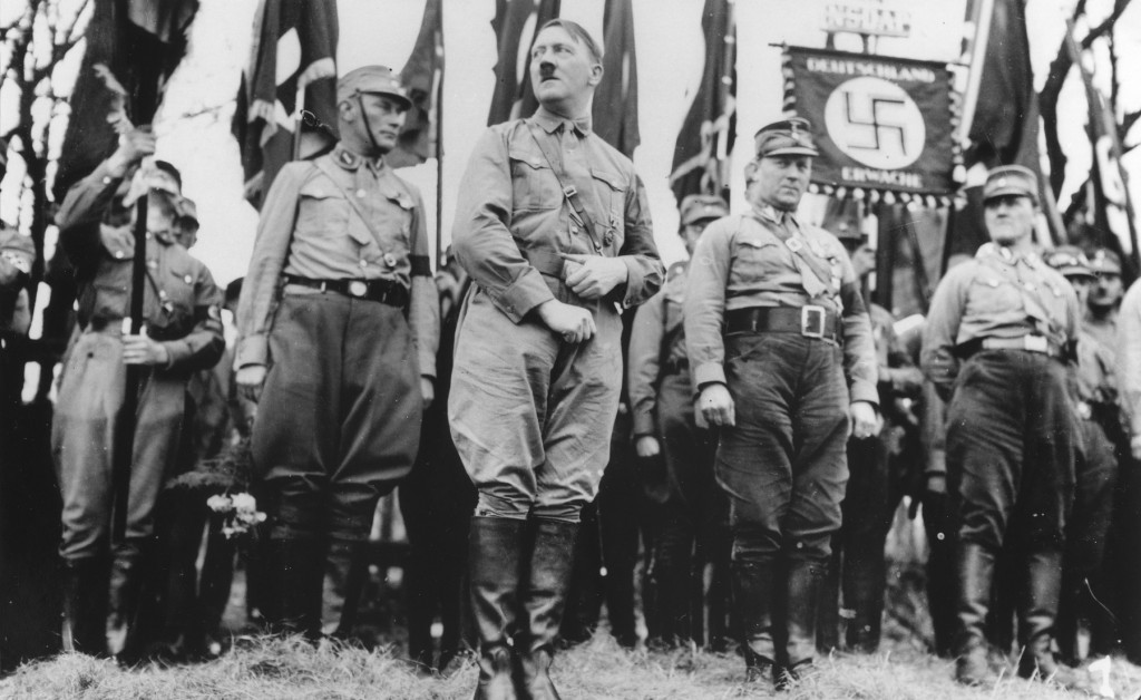 <p>Adolf Hitler stands with an SA unit during a Nazi parade in Weimar, where the constitution of the Weimar Republic was drafted in 1919. Weimar, Germany, 1931.</p>