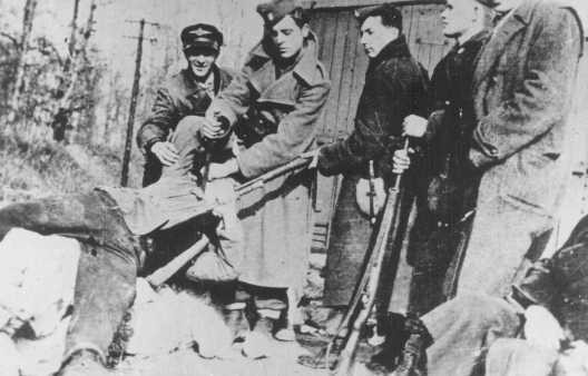 Ustasa (Croatian fascist) soldiers kill a victim with a dagger and bayonet. [LCID: 78515]