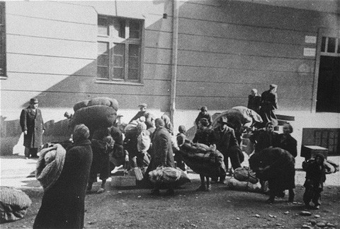 Macedonian Jews leave the Tobacco Monopoly transit camp in Skopje for the deportation trains. [LCID: 79743]