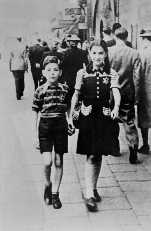 Jewish children wearing the compulsory yellow badge.