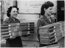 Members of the British Auxiliary Territorial Service carry rifles shipped from the United States under the Lend-Lease Act.