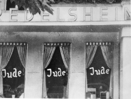 Windows of a Jewish-owned business in Berlin painted with the word "Jude" (Jew). [LCID: 00239]