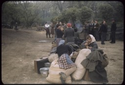 Displaced persons wait next to their suitcases and bundles, place uncertain, ca. [LCID: 67800]