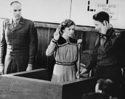 Fifteen-year-old Maria Dolezalova is sworn in as a prosecution witness at the RuSHA Trial. Dolezalova was among the children kidnapped by German forces after they destroyed the town of Lidice, Czechoslovakia. Nuremberg, October 30, 1947.