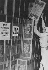 Boxes of matzah in a Joint Distribution Committee warehouse before distribution to Jewish survivors in displaced persons camps. Place uncertain, postwar.