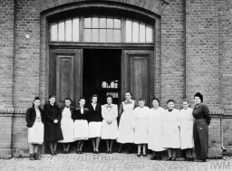 Some of the nursing staff of the "euthanasia" clinic at Hadamar stand outside of the institution after the arrival of US forces, April 5, 1945. Irmgard Huber, the head nurse of the clinic, is probably the person standing fifth from the right. © IWM EA 62183
