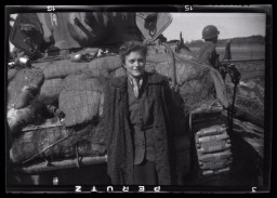 Gina Rappaport stands next to an American tank after liberation.