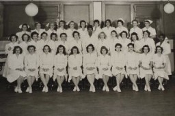 Blanka (middle row, third from right) graduates to become a pediatric nurse. December 1947.