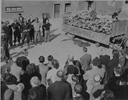 German civilians under US military escort are forced to view a wagon piled with corpses in the newly liberated Buchenwald concentration camp. Buchenwald, Germany, April 16, 1945.