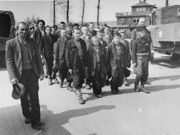 Children march out of Buchenwald to a nearby American field hospital where they will receive medical care. [LCID: 69225]