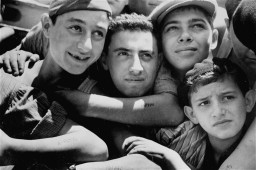 Youths with camp numbers tattooed on their arms aboard Aliyah Bet ("illegal" immigration) ship "Mataroa," at the Haifa port. [LCID: 69100]