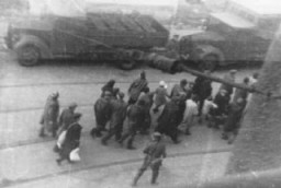 Jews captured during the Warsaw ghetto uprising are marched past the St. Zofia hospital down Nowolipie Street towards the Umschlagplatz for deportation. 