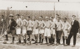 Members of a soccer team in Bitola pose in the goal of a sports field. August 14, 1928.