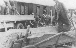 Roma (Gypsies) remove bodies from the Iasi-Calarasi death train during its stop in Tirgu-Frumos. Two trains left Iasi on June 30, 1941, bearing survivors of the pogrom that took place in Iasi on June 28-29. Hundreds of Jews died on the transports aboard crowded, unventilated freight cars in the heat of summer. Romania, July 1, 1941.