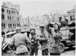 US Army Signal Corps photographers from Combat Unit 123 photograph ruins in the city of Naumburg, Germany. Photograph taken by J Malan Heslop. April 10, 1945.