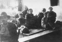 Jews from Bulgarian-occupied Macedonia who were rounded up and assembled at the Tobacco Monopoly transit camp in Skopje before deportation to the Treblinka killing center. Skopje, Yugoslavia, March 1943.
The Jews of Bulgarian-occupied Thrace and Macedonia were deported in March 1943. On March 11, 1943, over 7,000 Macedonian Jews from Skopje, Bitola, and Stip were rounded up and assembled at the Tobacco Monopoly in Skopje, whose several buildings had been hastily converted into a transit camp. The Macedonian Jews were kept there between eleven and eighteen days, before being deported by train in three transports between March 22 and 29, to Treblinka.