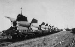 Sections of V-2 rockets, the so-called Vengeance Weapons, are removed by rail from the Dora-Mittelbau camp after liberation. Near Nordhausen, Germany, June 1945.