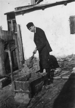 Naftali Saleschutz prepares cement for the foundation of a sukkah (a hut-like structure used to celebrate the Jewish holiday of Sukkot). [LCID: 10879]