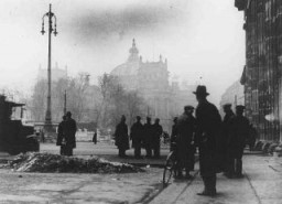 Onlookers in front of the Reichstag (German parliament) building the day after it was damaged by fire. On this same day, the Nazis implemented the Decree of the Reich President for the Protection of the People and the State. It was one of a series of key decrees, legislative acts, and case law in the gradual process by which the Nazi leadership moved Germany from a democracy to a dictatorship. Berlin, Germany, February 28, 1933.