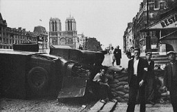 During the battle to liberate the French capital, a barricade is hastily built near the cathedral of Notre Dame. Paris, France, August 1944.