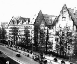 <p>View of the Palace of Justice (left), where the <a href="/narrative/9366">International Military Tribunal</a> trial was held. Nuremberg, Germany, November 17, 1945.</p>
<p>The Palace of Justice was selected by the Allied powers as the <a href="/narrative/9695">location</a> for the International Military Tribunal (IMT) because it was the only undamaged facility extensive enough to accommodate a major trial. The site contained 20 courtrooms and a prison capable of holding 1,200 prisoners.</p>